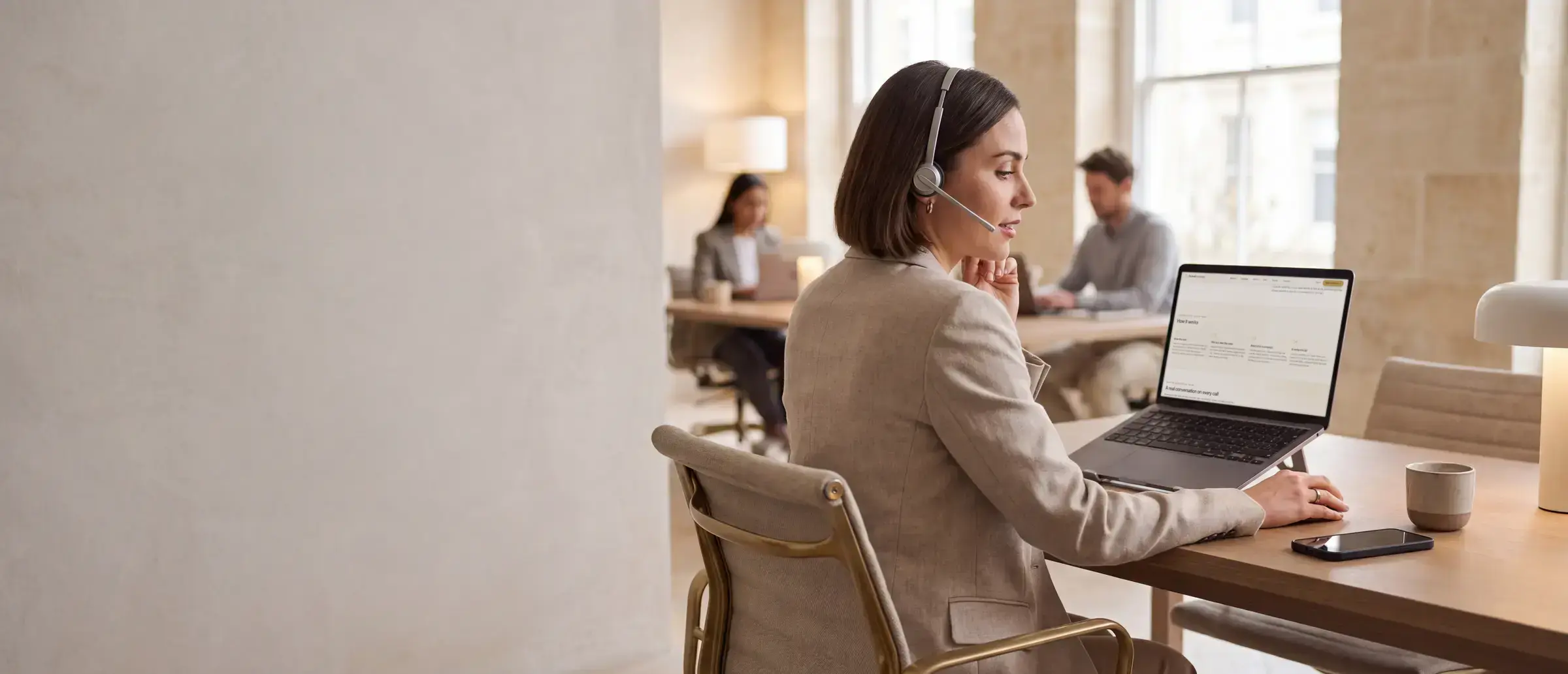 A campaign manager in a headset listening to an AI agent's live call, PacketExchange open on her laptop